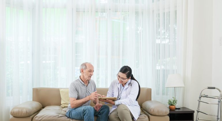 Cheerful doctor showing tablet to senior patient Will anxiety medication help