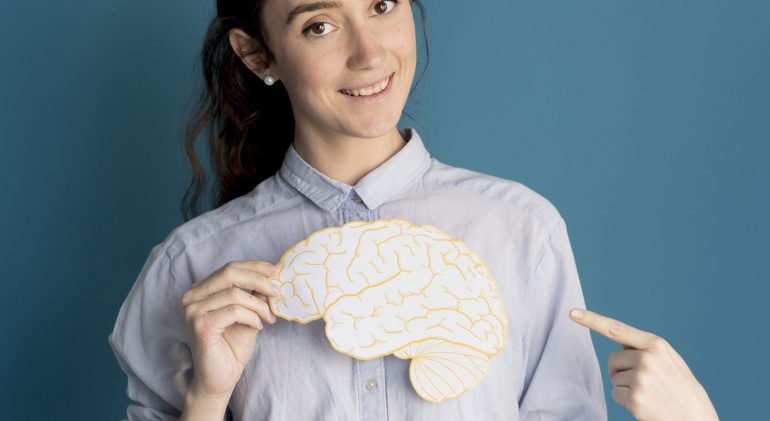 smiley-woman-holding-paper-brain what helps reduce anxiety
