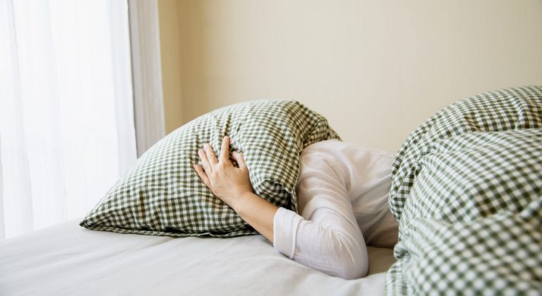 lady-cover-her-head-by-pillow-bed (1) Adolescent Depression Statistics Uk