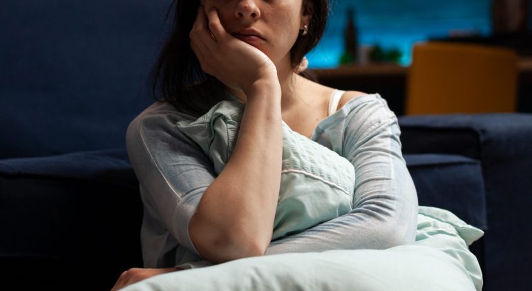 Portrait of sad person with depression problems in living room adolescent depression nice guidelines
